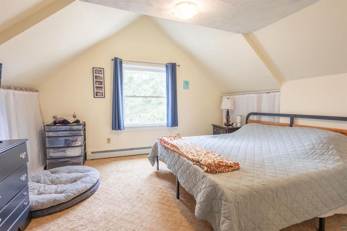 Second upstairs bedroom under the roofline.