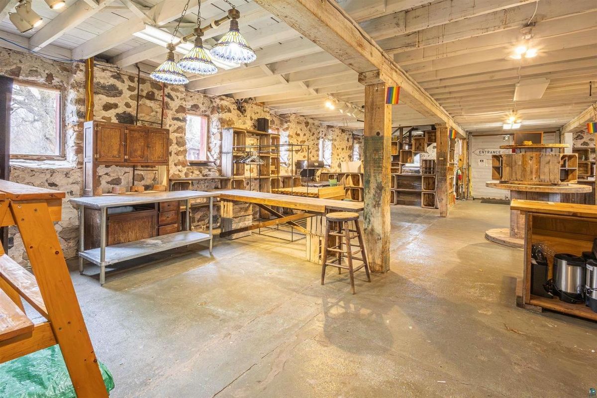 The barn's lower level with worktables between timber posts.